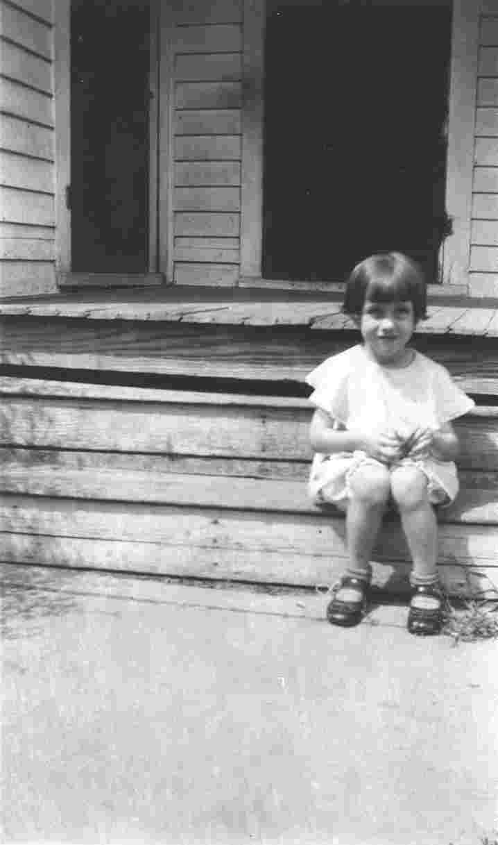 Betty van Borkum, age 7, on the steps.
